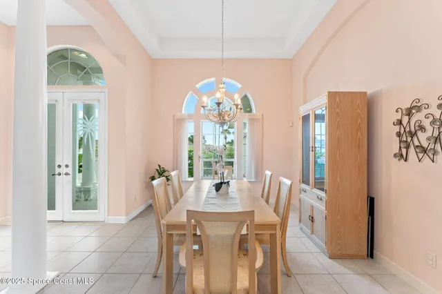 a view of a dining room with furniture and a chandelier