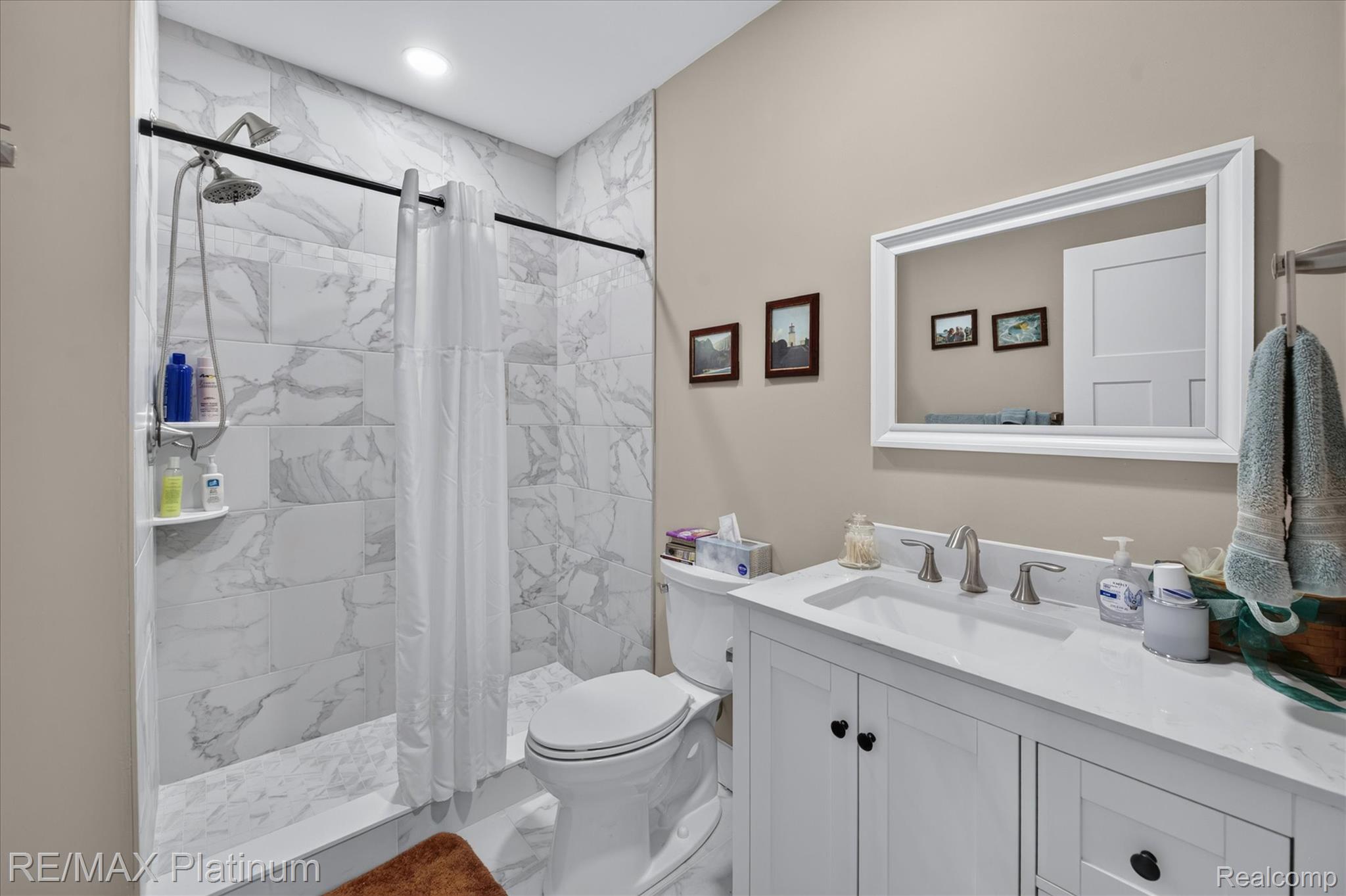 2676 Crooked Lake Road Howell, MI 48843 - Photo 41 of 60 Bathroom featuring a white vanity with integrated sink, brushed nickel faucet, and a large framed mirror