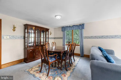 a bathroom with a tub a sink and a large mirror
