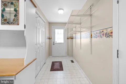 a bedroom with a bed wooden floor and flat screen tv