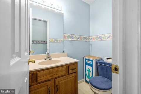 a view of hallway with stairs and wooden floor