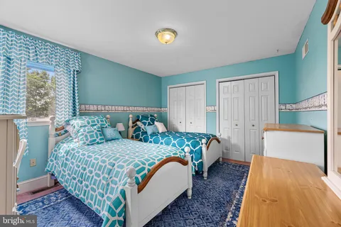 a view of staircase with railing and white walls