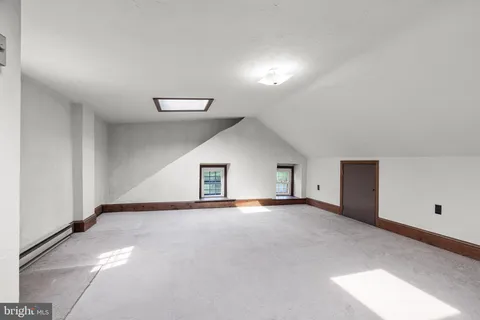 a bathroom with a toilet and a mirror