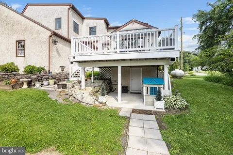 a view of a swimming pool with lawn chairs under an umbrella