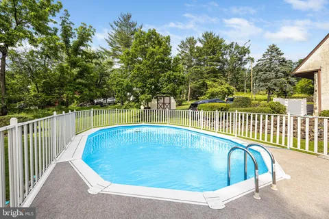 a view of a swimming pool with a yard