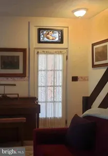 a living room with furniture cabinets and window