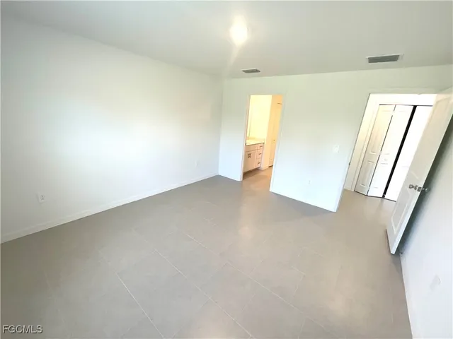 a view of an empty room and a window