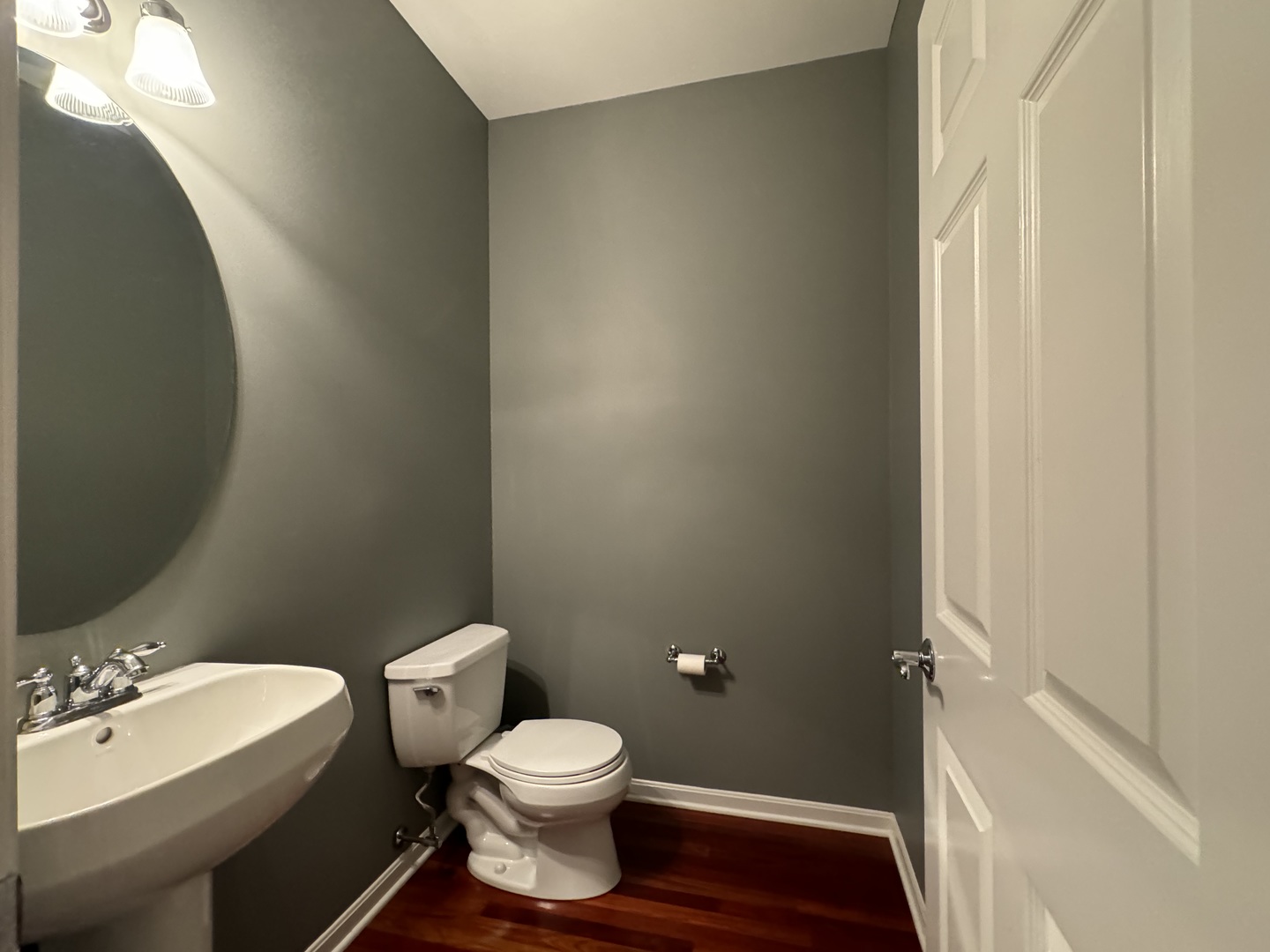 4535 West Irving Park Road Chicago, IL 60641 - Photo 7 of 15 a white toilet sitting next to a bathroom sink