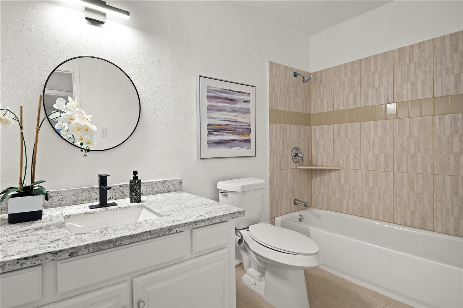 559 Demarett Drive Point Venture, TX 78645 - Photo 13 of 23 Full bath with vanity and bathtub / shower combination