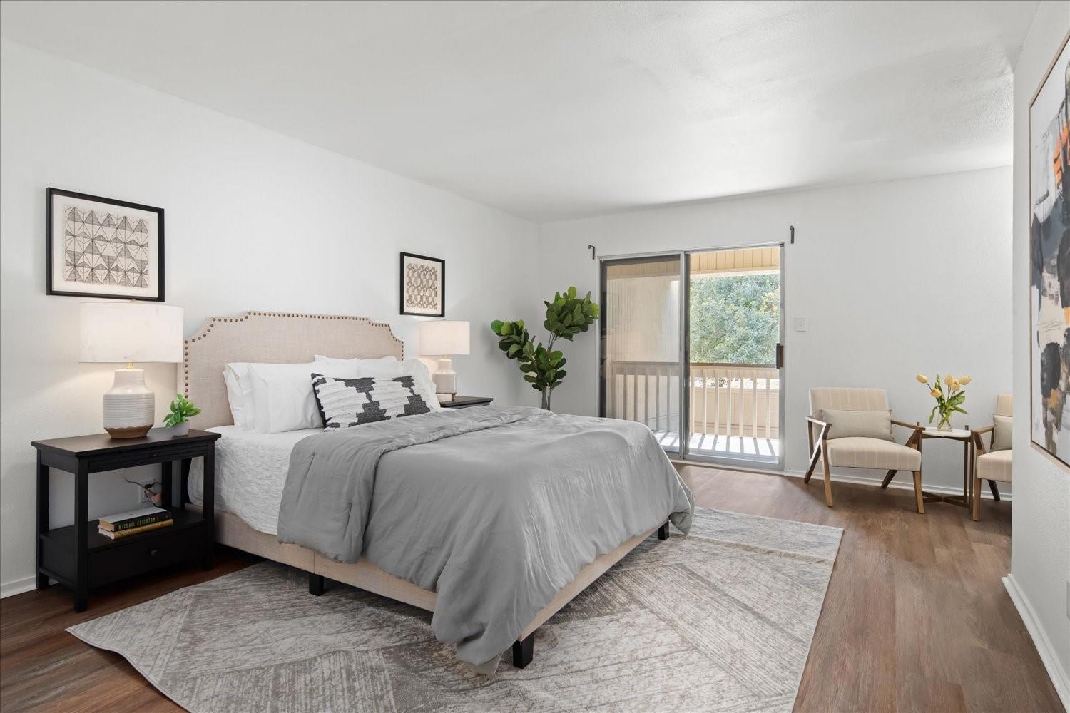 559 Demarett Drive Point Venture, TX 78645 - Photo 18 of 23 Bedroom with access to exterior and dark wood-style floors