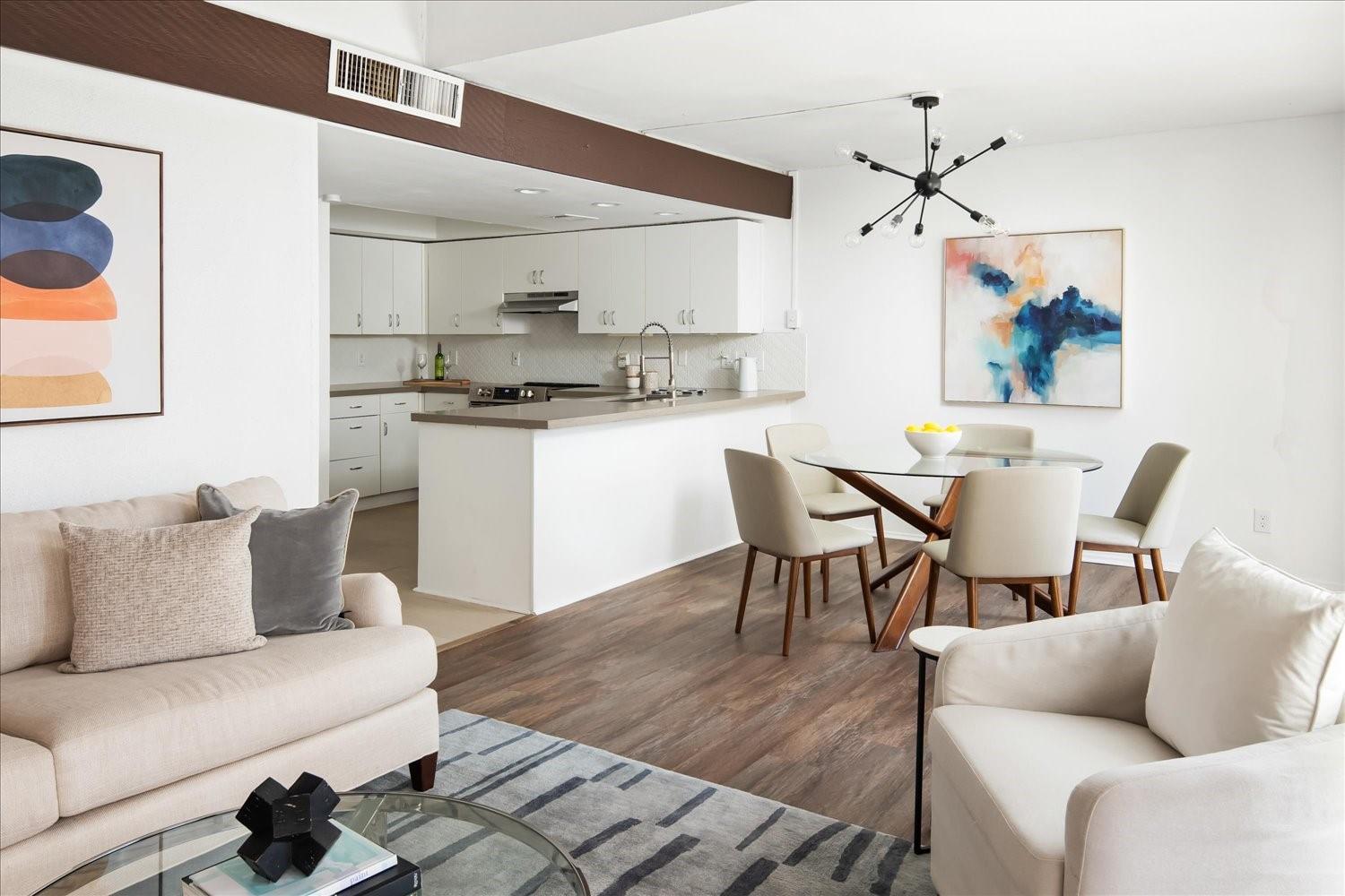 559 Demarett Drive Point Venture, TX 78645 - Photo 10 of 23 Living room with wood finished floors and a chandelier