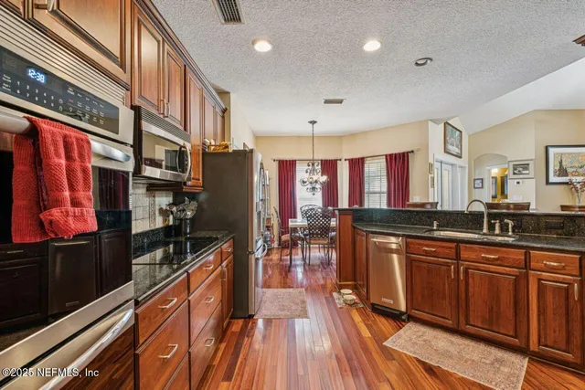 a bedroom with furniture and wooden floor