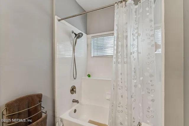 a bathroom with a granite countertop double vanity sink and mirror