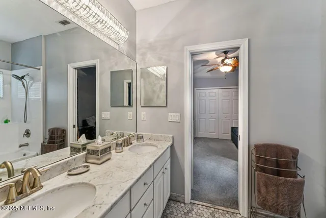 a bedroom with a bed and a flat tv screen on the dresser