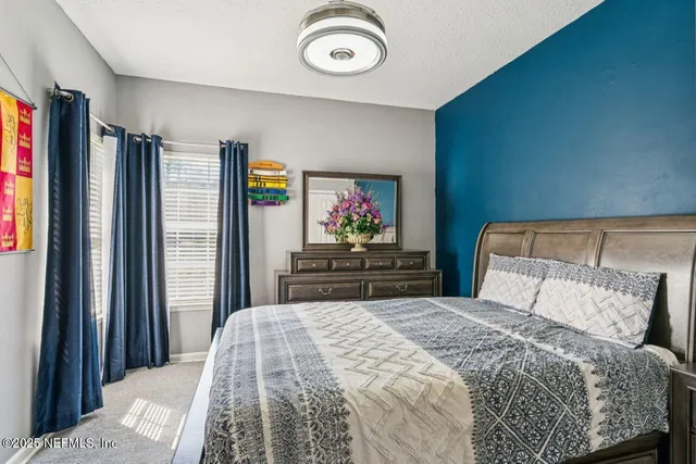 a bedroom with a bed and a potted plant