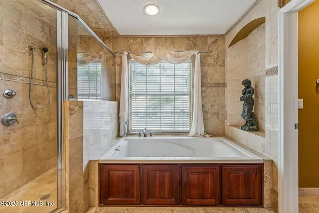 a bathroom with a granite countertop sink a mirror and a shower