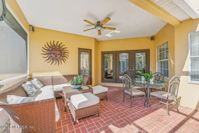 a living room with furniture and a floor to ceiling window