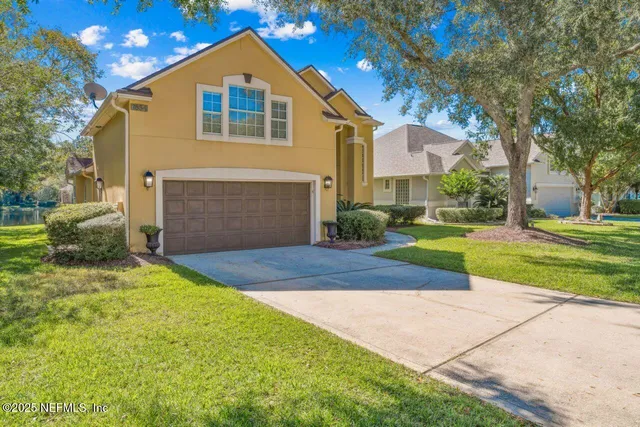 a front view of a house with a yard and garage