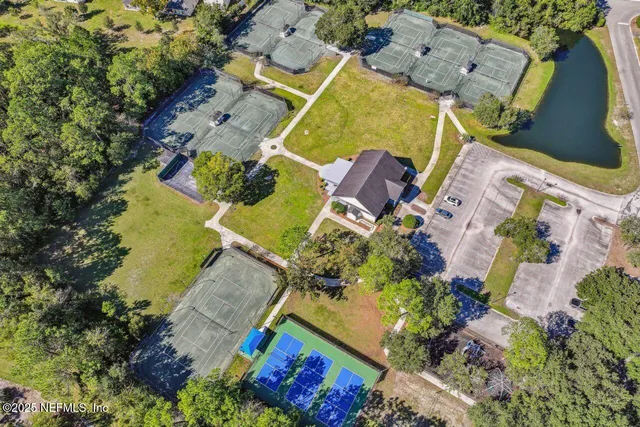 a view of a balcony with chairs and wooden fence