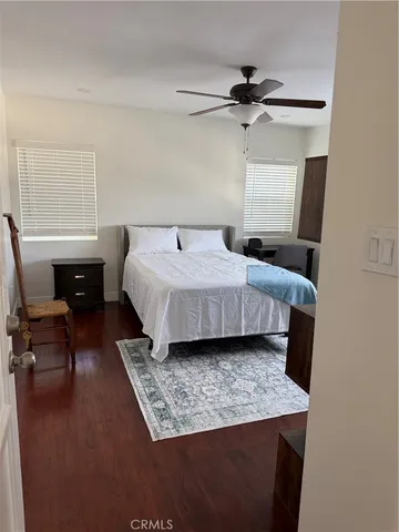 a bedroom with a bed window and a table