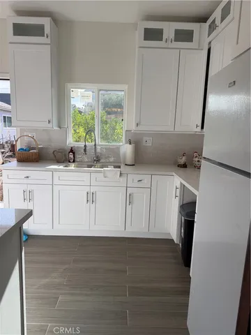 a kitchen with stainless steel appliances granite countertop a sink a stove and a refrigerator