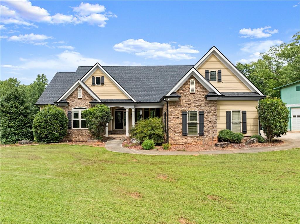 a front view of a house with yard and green space