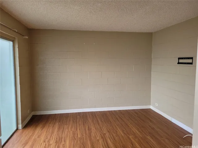 a view of an empty room and wooden floor
