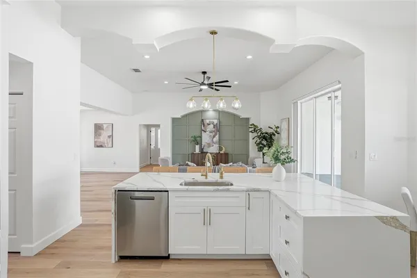 a large white kitchen with a large window