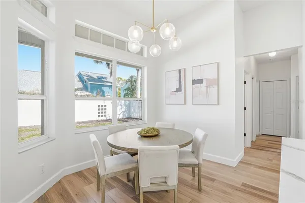 a living room with kitchen island furniture and a chandelier