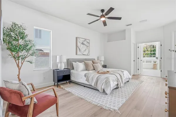 a bedroom with a bed and wooden floor