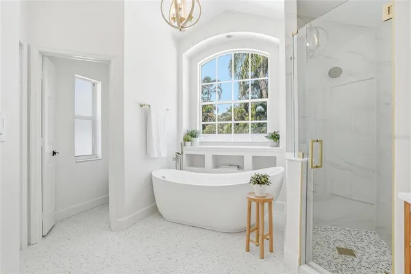 a white bath tub sitting next to a shower