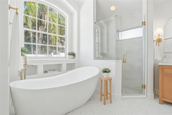 a bathroom with a granite countertop sink toilet and mirror