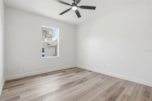 a bathroom with a granite countertop toilet a sink and a mirror