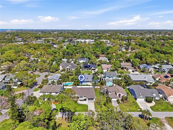 a front view of a house with a garden and yard