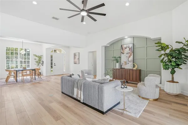 a living room with furniture and wooden floor
