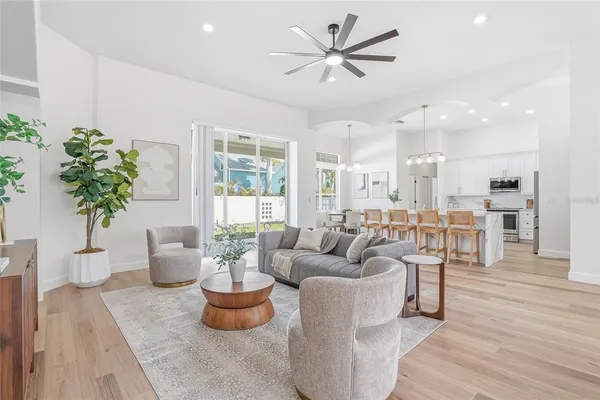 a living room with furniture potted plant and a chandelier