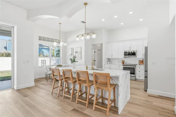 a large kitchen with a table and chairs