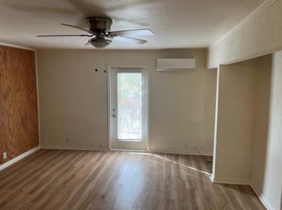 230 Six Pines Road San Marcos, TX 78666 - Photo 13 of 21 an empty room with wooden floor fan and windows