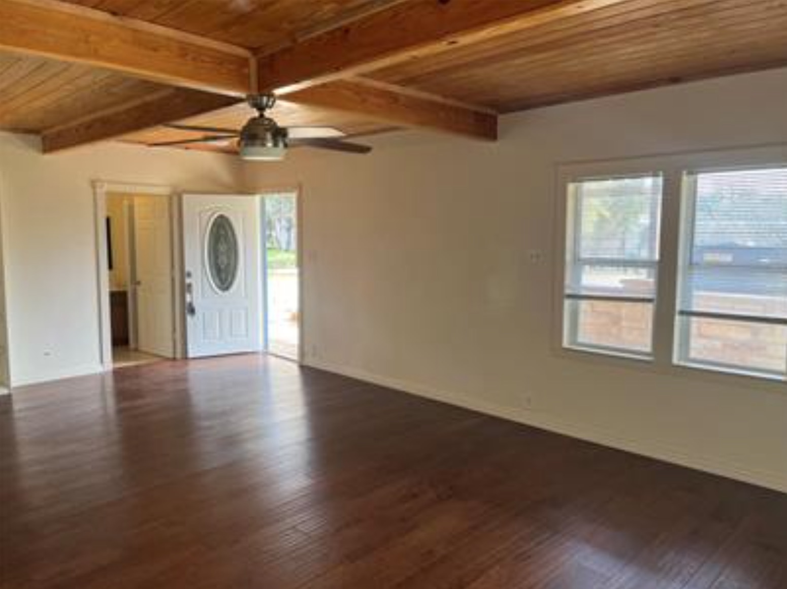 230 Six Pines Road San Marcos, TX 78666 - Photo 5 of 21 a view of a livingroom with wooden floor and a ceiling fan