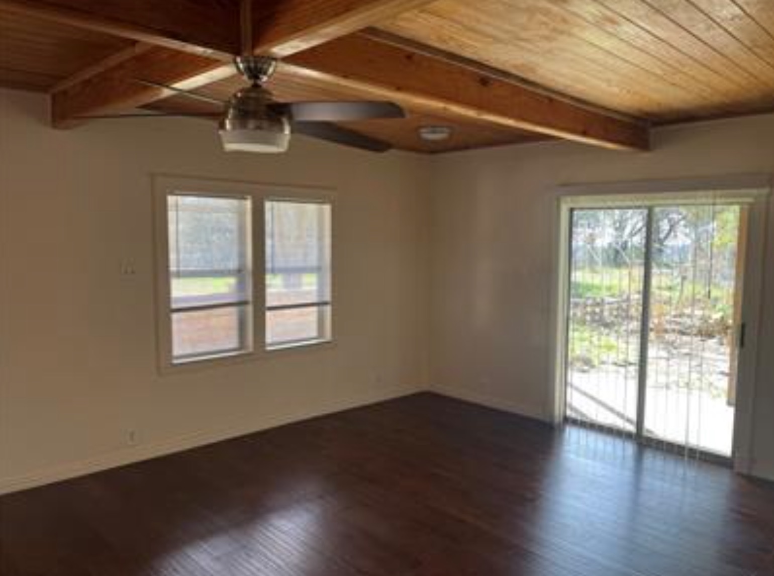 230 Six Pines Road San Marcos, TX 78666 - Photo 6 of 21 an empty room with wooden floor fan and windows
