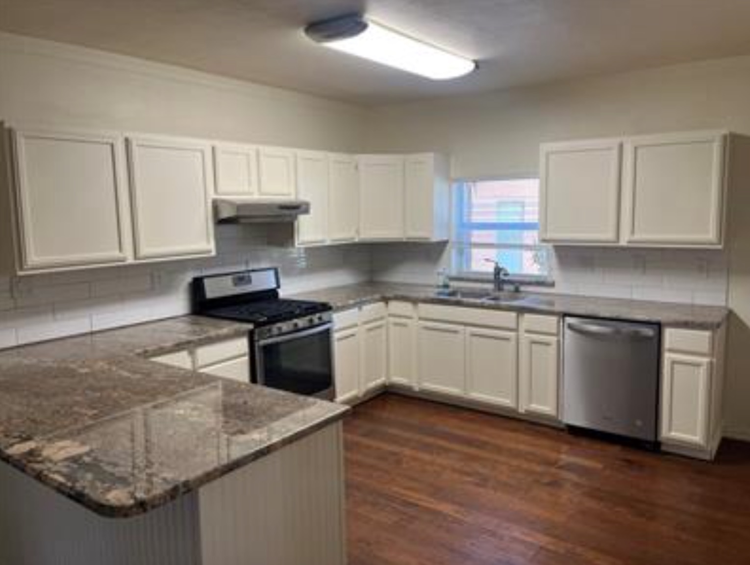 230 Six Pines Road San Marcos, TX 78666 - Photo 7 of 21 a kitchen with granite countertop white cabinets and white appliances