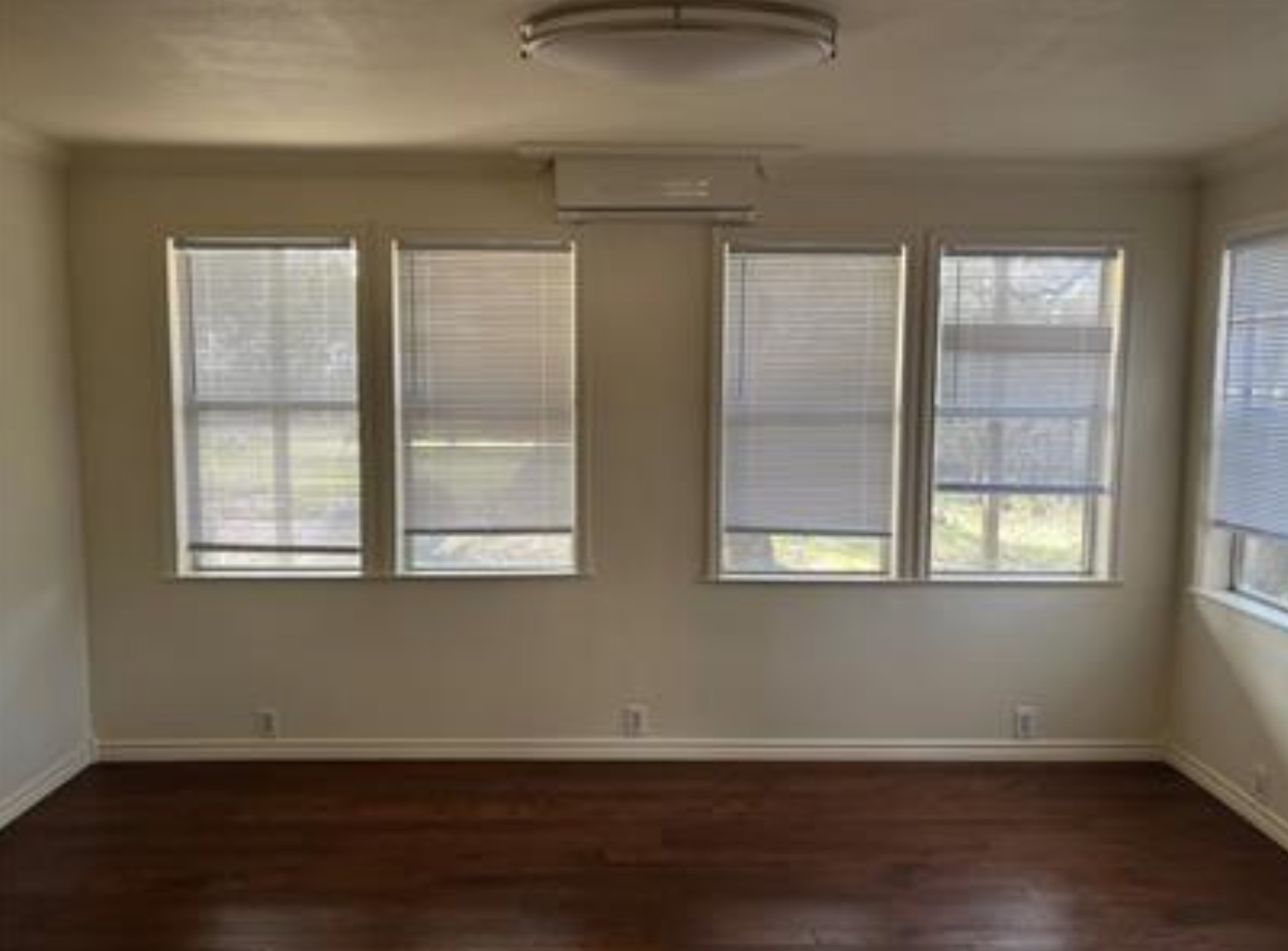 230 Six Pines Road San Marcos, TX 78666 - Photo 8 of 21 an empty room with wooden floor and windows