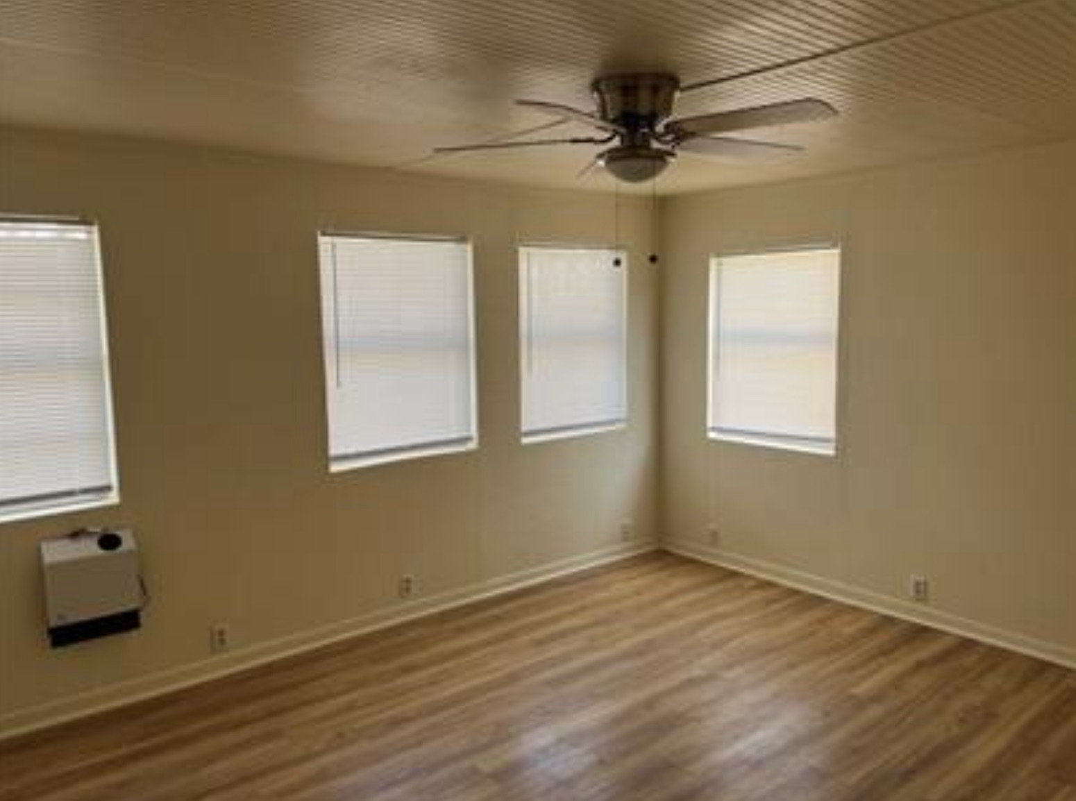 230 Six Pines Road San Marcos, TX 78666 - Photo 10 of 21 a view of an empty room with a window and wooden floor