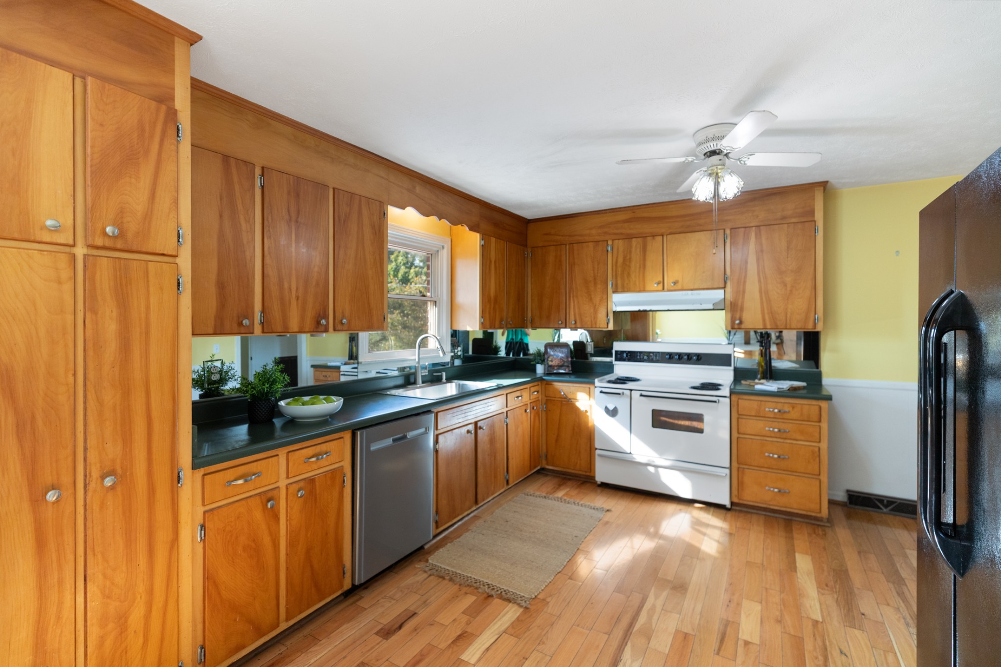 1380 Cowan Road Dickson, TN 37055 - Photo 21 of 61 a kitchen with stainless steel appliances granite countertop a refrigerator a sink dishwasher a stove and white cabinets with wooden floor