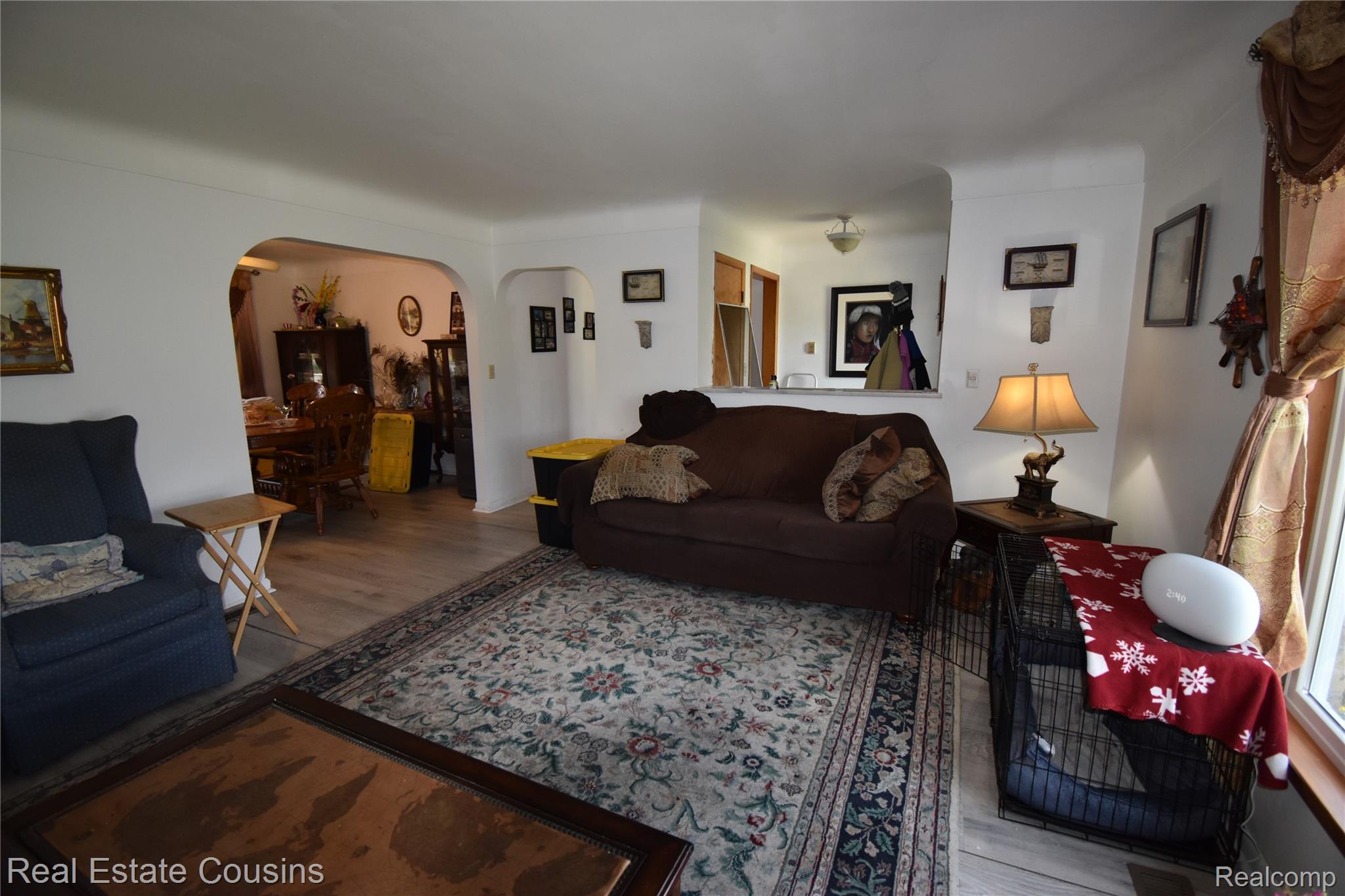 2247 Johnson Mill Road North Branch, MI 48461 - Photo 16 of 22 Spacious living area featuring wood-finish flooring, a decorative area rug, and arched doorways