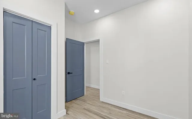 a view of hallway with wooden floor