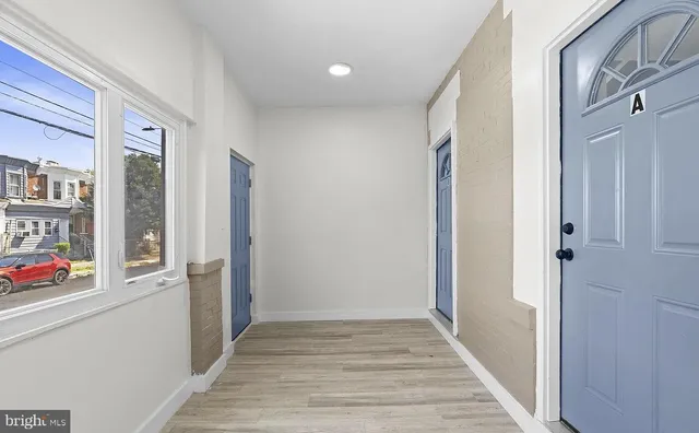 a view of an entryway with wooden floor