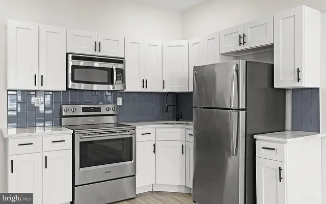 a kitchen with cabinets stainless steel appliances and wooden cabinets