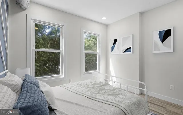 a bedroom with a large bed and a window