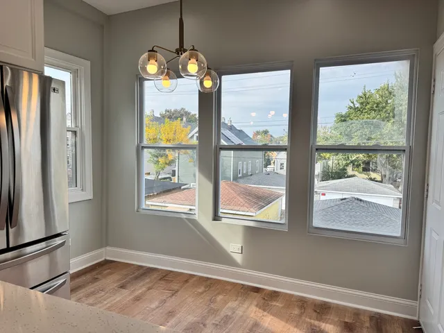a view of an empty room and wooden floor
